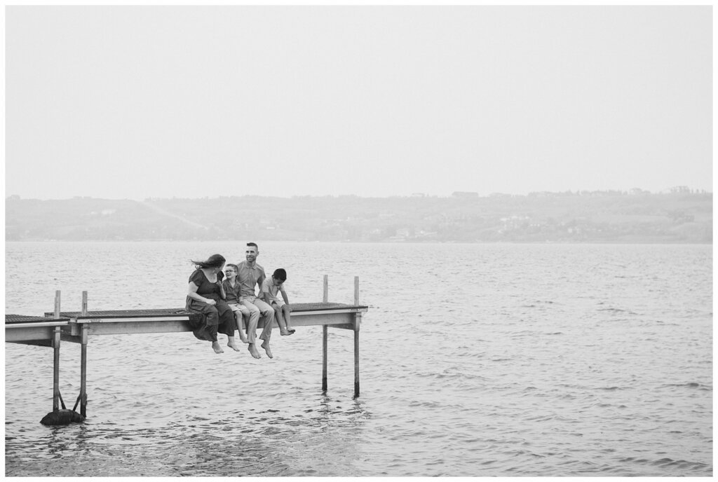 Jaarsma Family - Lumsden Beach - 16 - Family sits on a dock