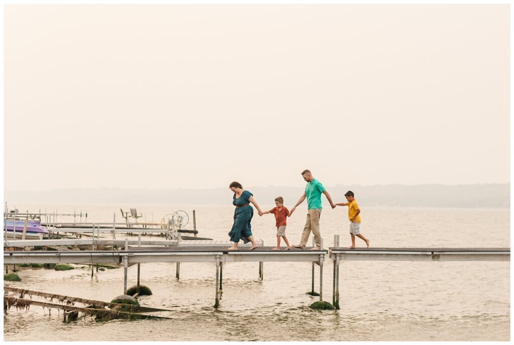 Jaarsma Family - Lumsden Beach - 17 - Family holds hands and walks on dock