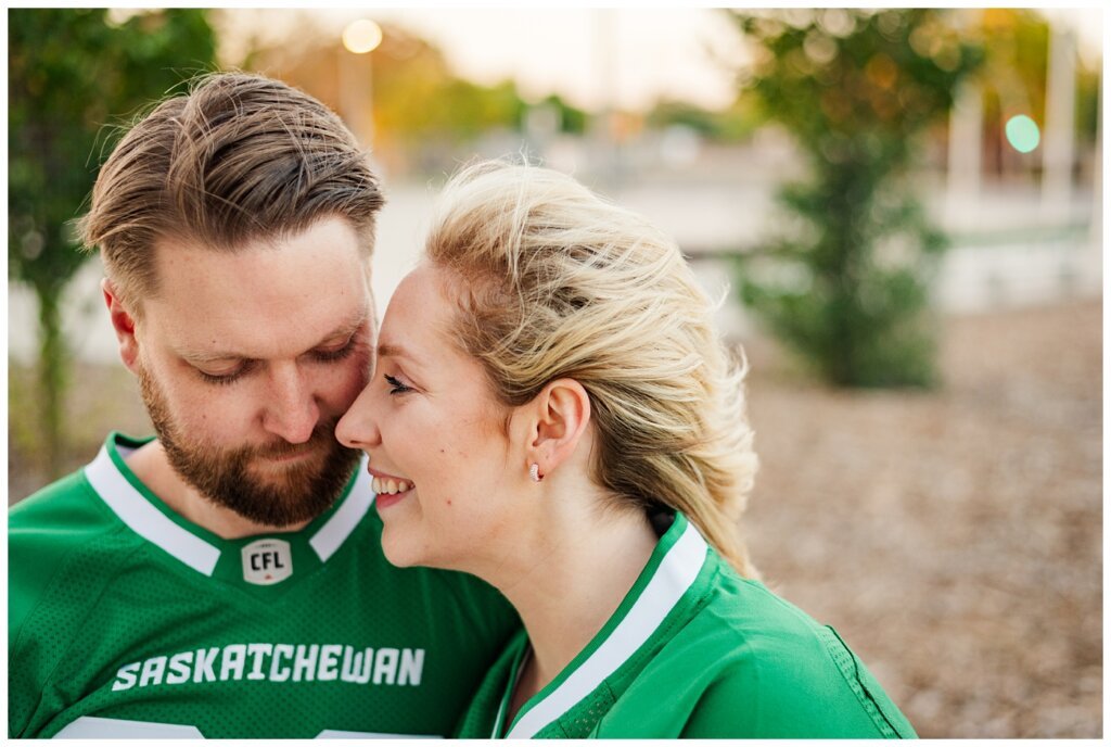 Lindskog Family - Mosaic Stadium - 11 - Couple smile at each other