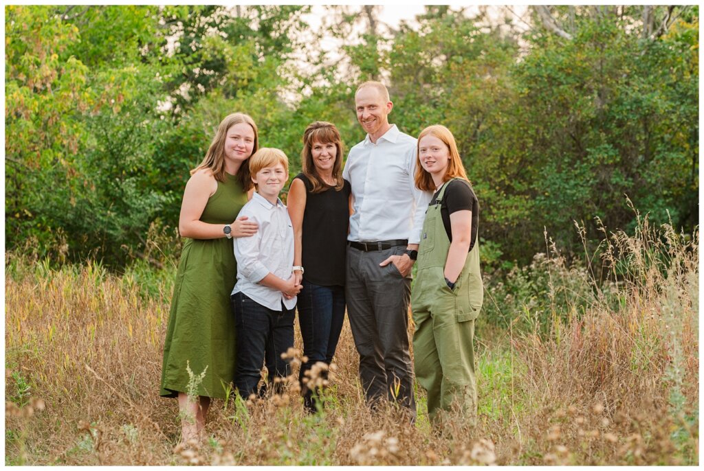 Schoenroth Family - AE Wilson Park - 02 - Family holds hands in tall grass