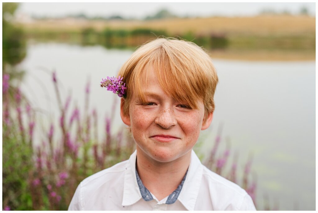 Schoenroth Family - AE Wilson Park - 08 - Boy with red hair puts purple flowers on his ear