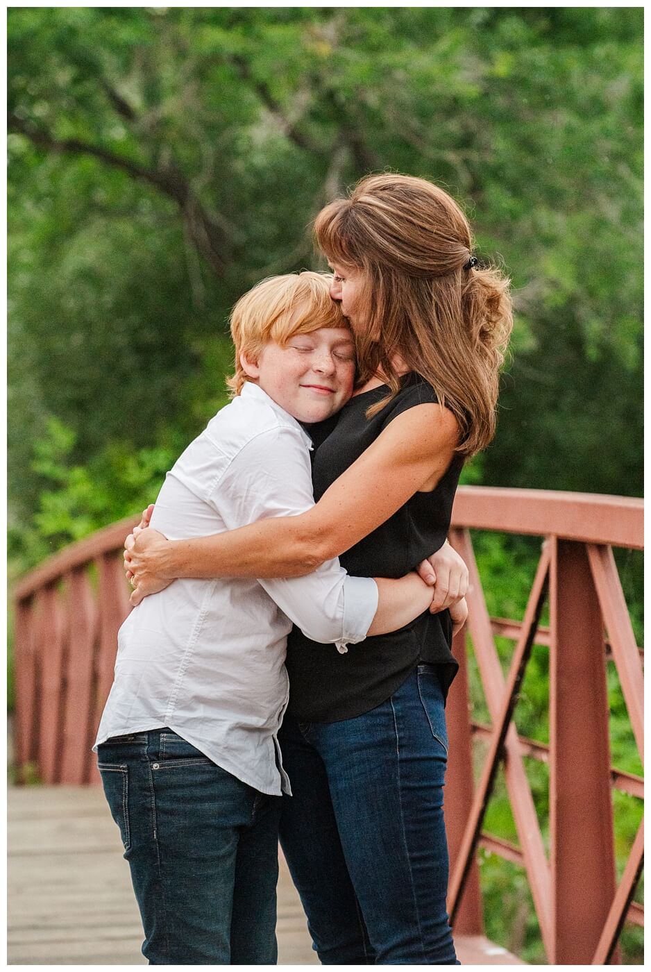 Schoenroth Family - AE Wilson Park - 15 - Mom hugs her son on a bridge