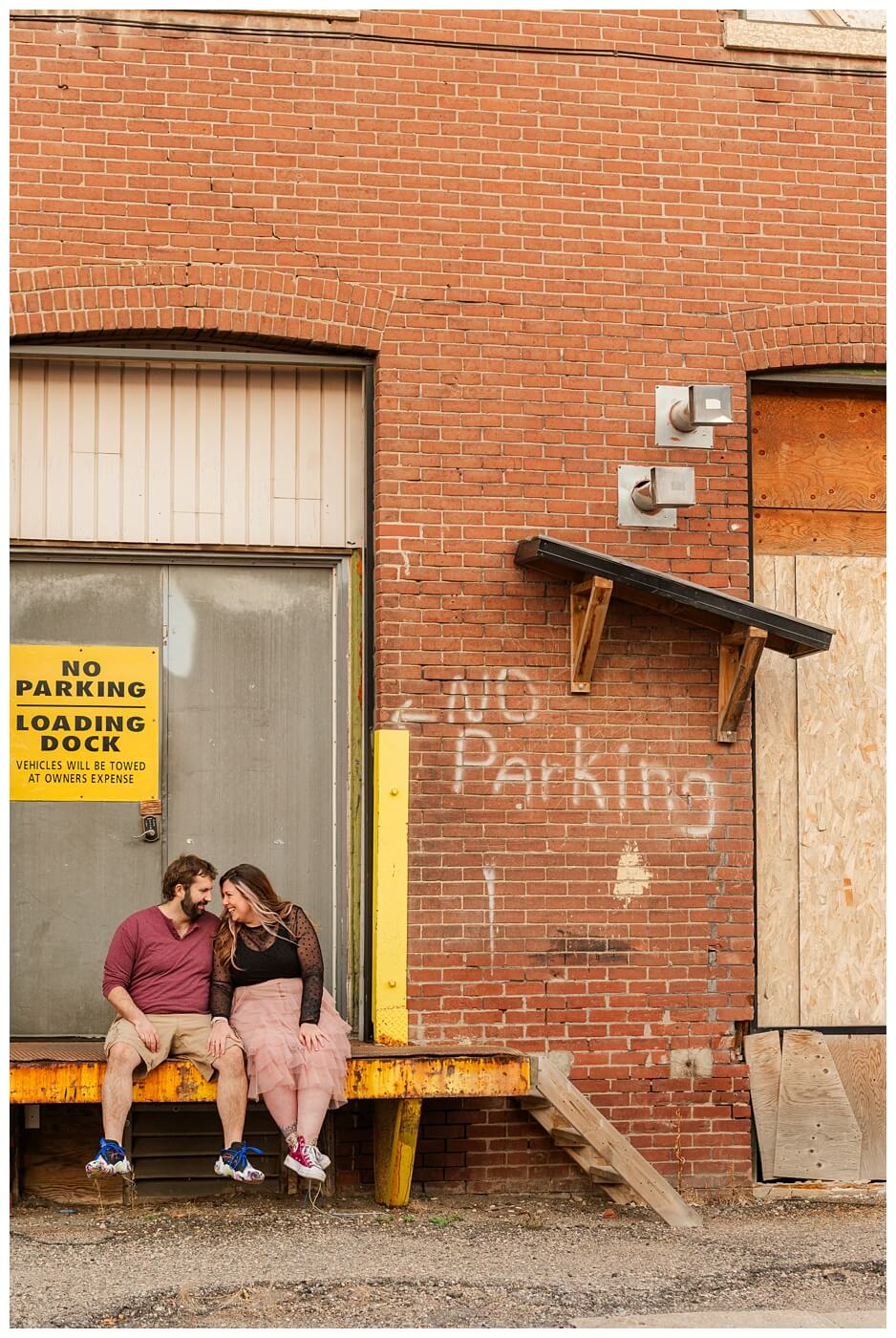 TJ & Danielle - Regina Warehouse District - 10 - Couple sits on loading dock