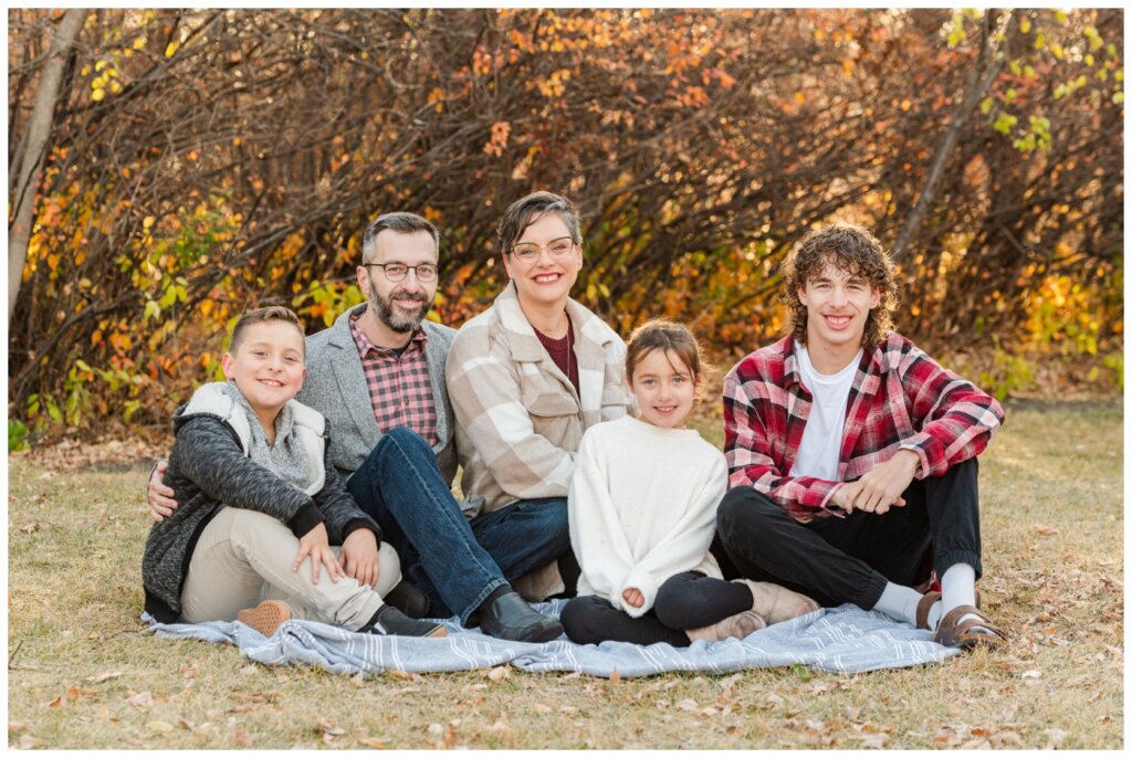 Schlamp Family - 12 - Wascana Park - Family sitting on blanket in the park
