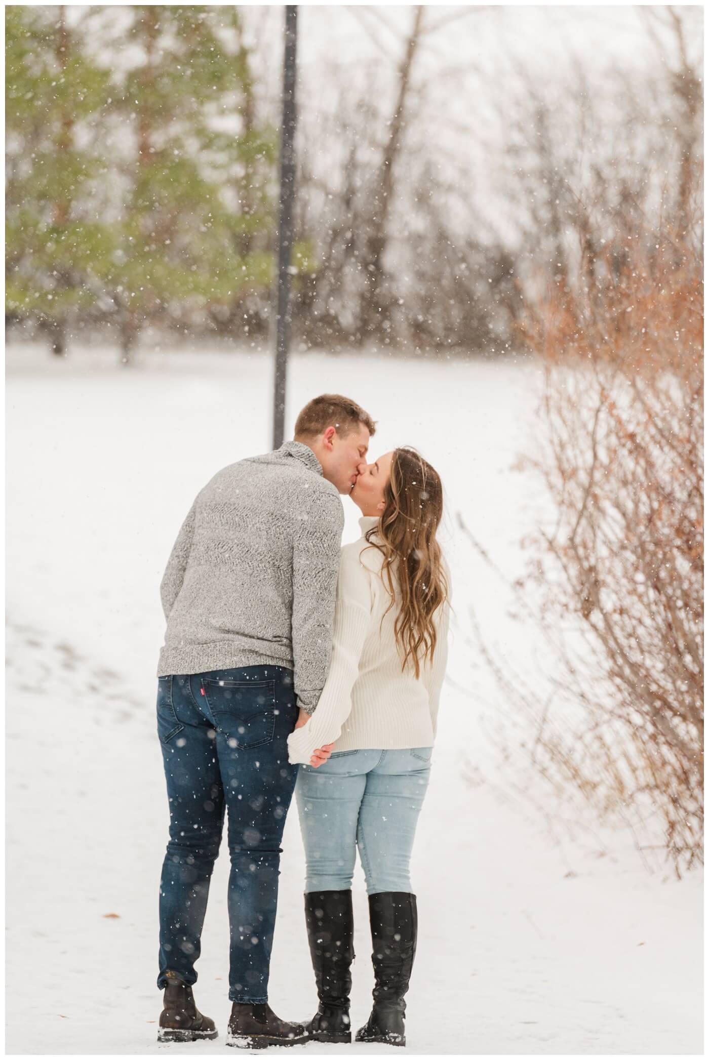 Michael & Briana - Engagement Session - 11 - UofR - Couple kissing in the snow