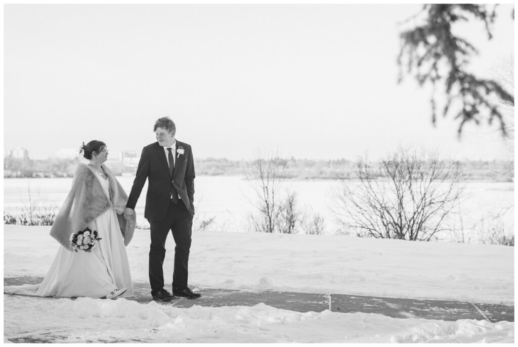 Kenneth & Marrick - Regina Winter Wedding - Wascana Park - 024 - Groom leads his wife along the path