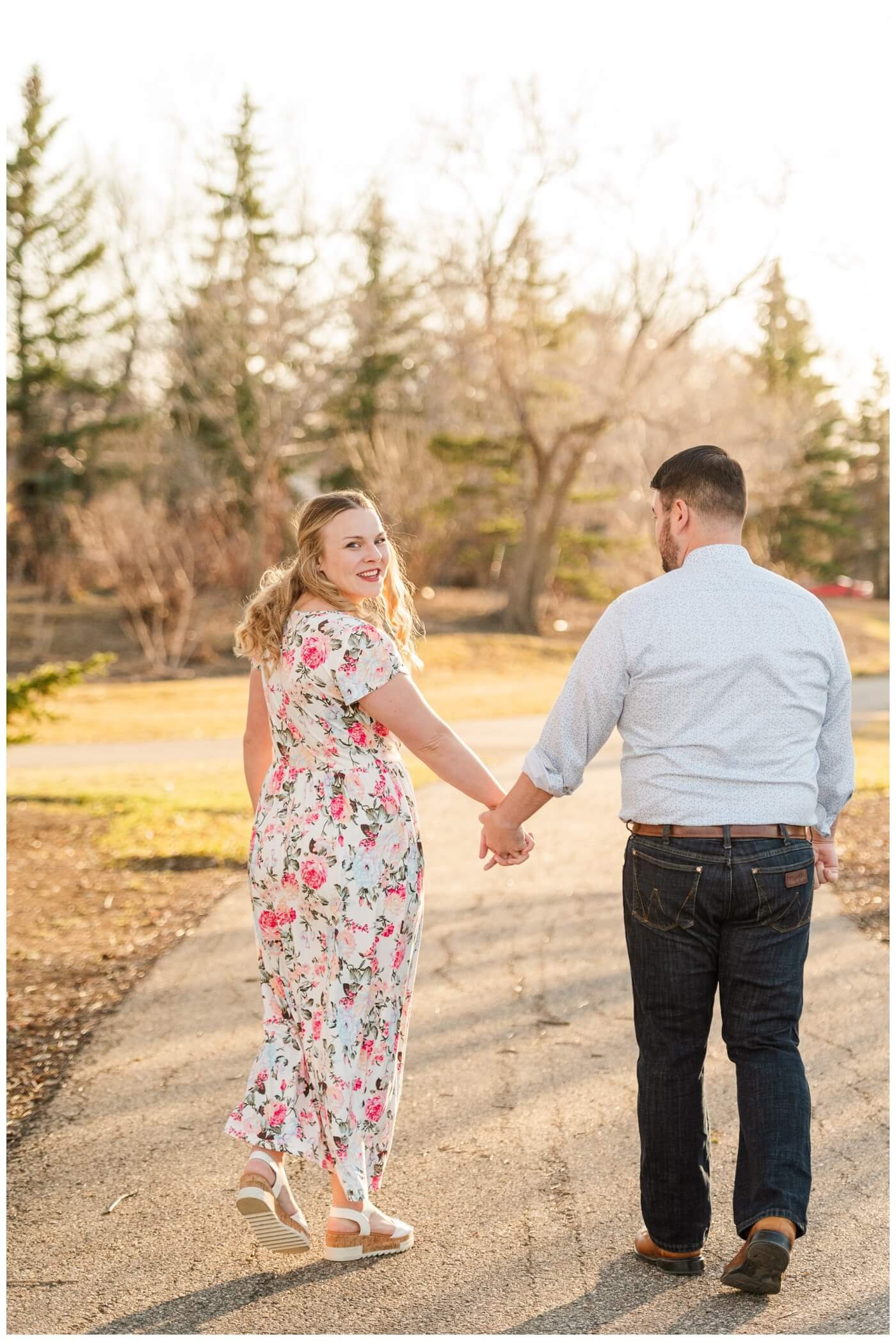 Darcy & Maddie - Regina Engagement - AE Wilson Park - 001 - Bride looks over her shoulder