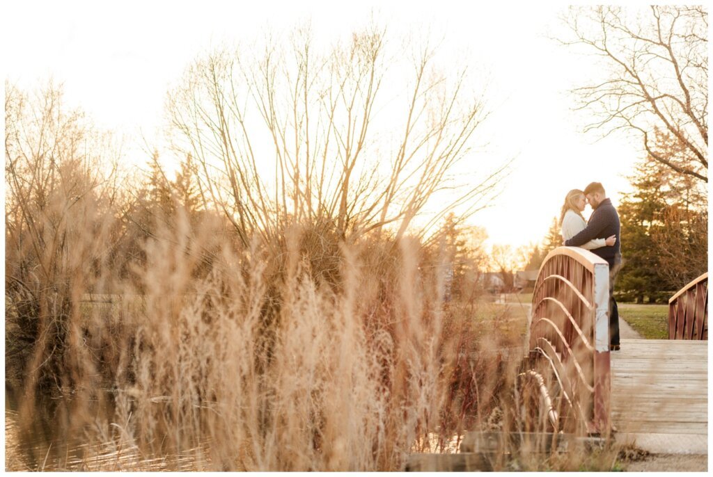 Darcy & Maddie - Regina Engagement - AE Wilson Park - 009 - Standing on the bridge to the island