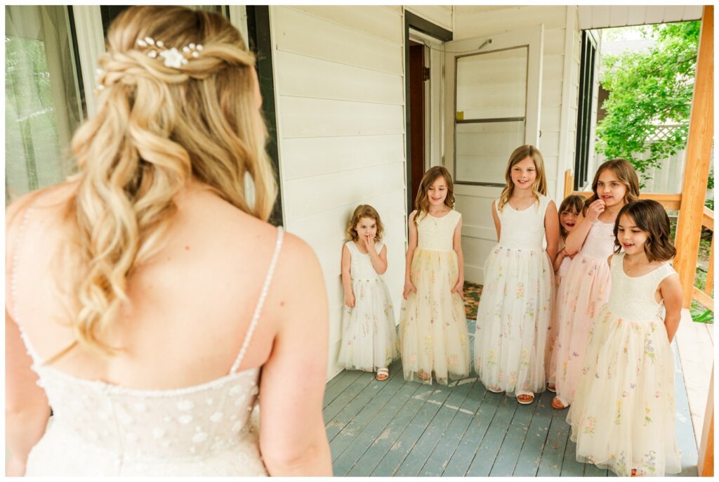 Darcy & Maddie - Regina Summer Wedding - 007 - Flower girls see bride in her dress
