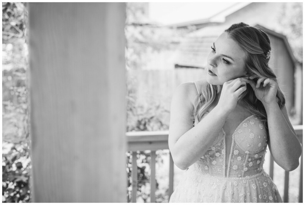 Darcy & Maddie - Regina Summer Wedding - 008 - Bride puts in her earrings