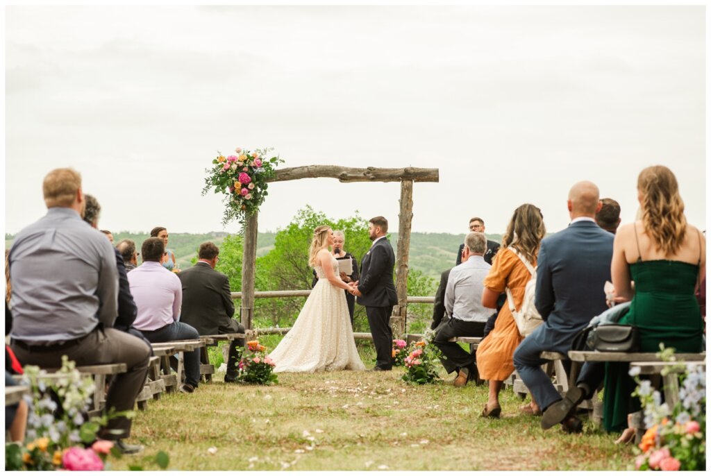 Darcy & Maddie - Regina Summer Wedding - 013 - Goodsman Farm - Bride & Groom exchange their vows
