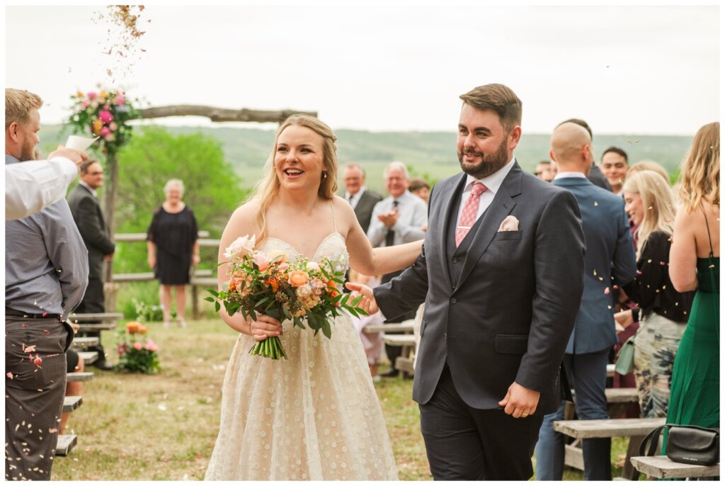Darcy & Maddie - Regina Summer Wedding - 015 - Goodsman Farm - Bride & Groom exit after ceremony