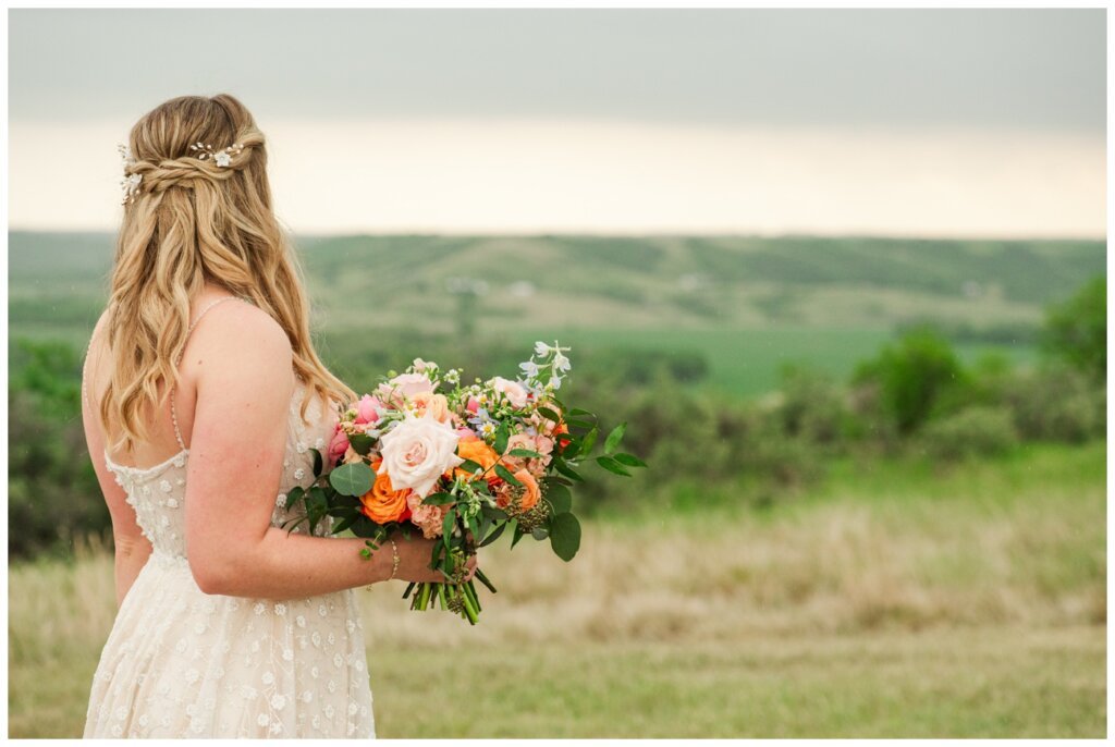 Darcy & Maddie - Regina Summer Wedding - 024 - Goodsman Farm - Bride with bright bouquet of flowers