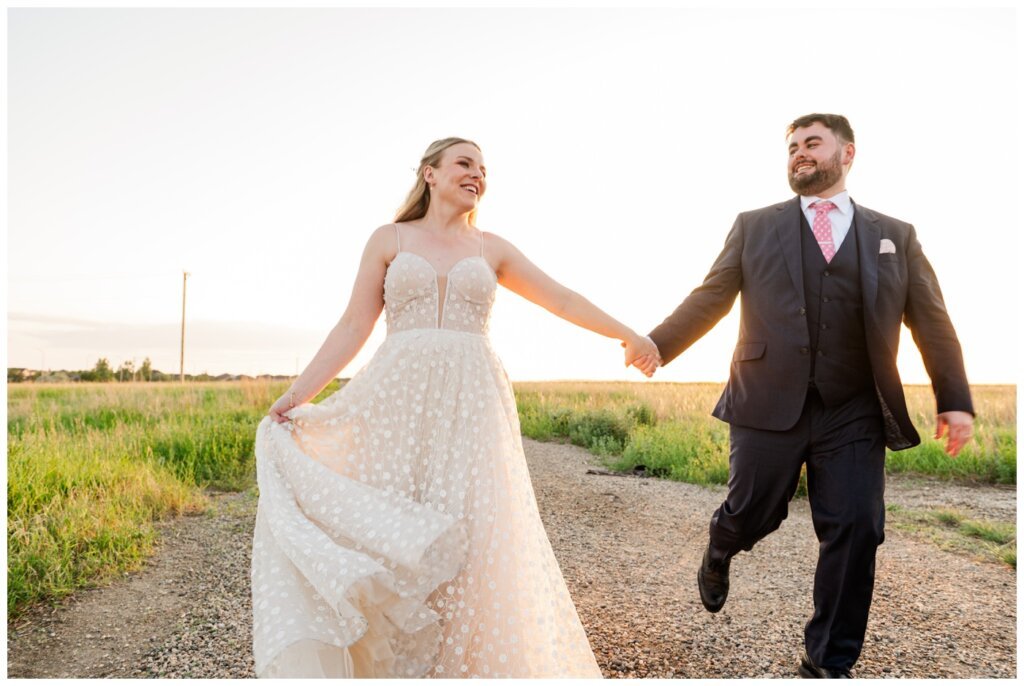 Darcy & Maddie - Regina Summer Wedding - 028 - Bride & Groom run at sunset