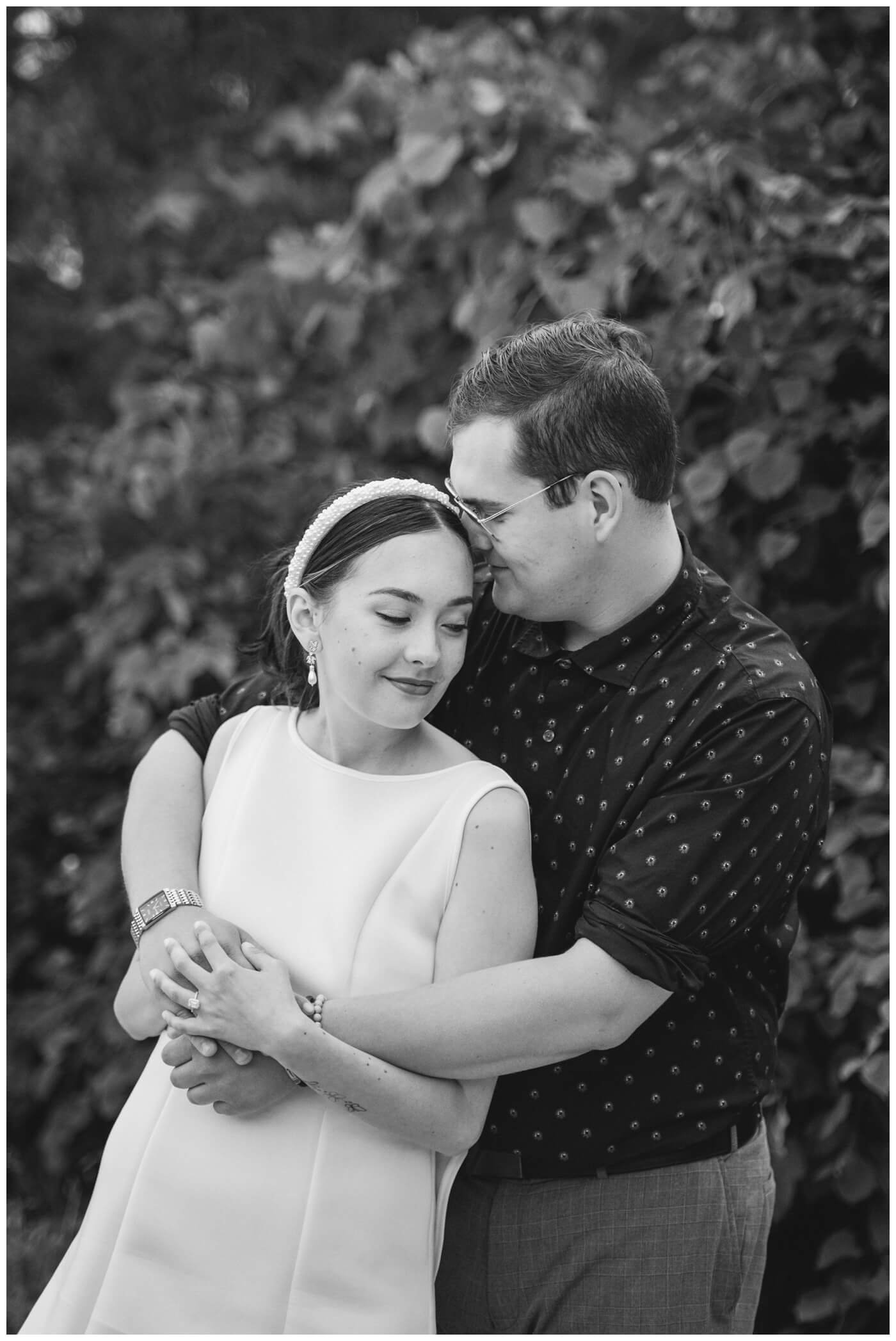 Skylar & Michaela- Regina Engagement - Wascana Park - 004 - Groom wraps up his bride