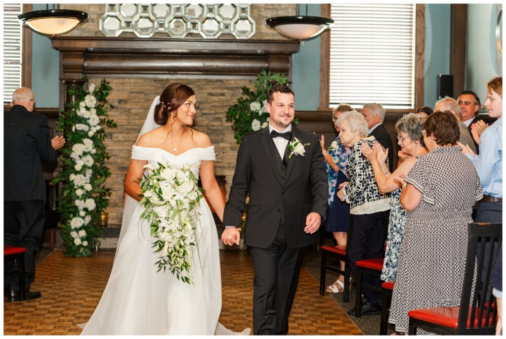 Derek & Danica - Regina Summer Wedding - 009 - Bride smiles at her groom as they walk out