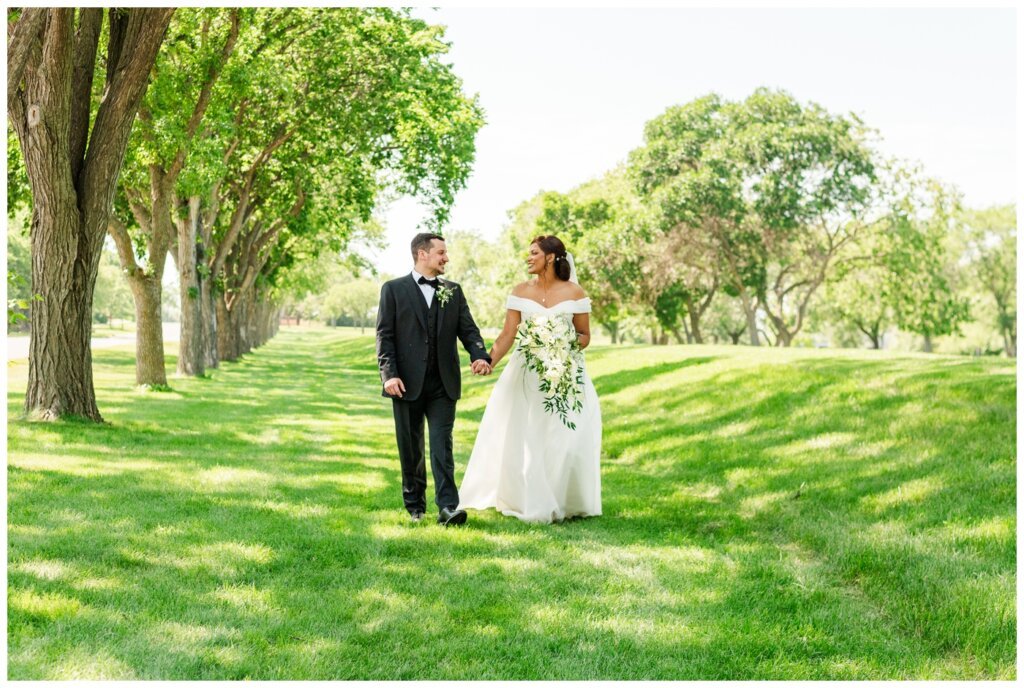 Derek & Danica - Regina Summer Wedding - 010 - Bride & Groom walk in the park
