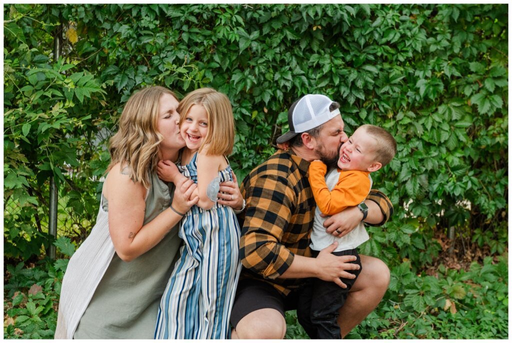 Eyre Family - Regina Family Photography - 003 - Parents kiss kids on the cheeks