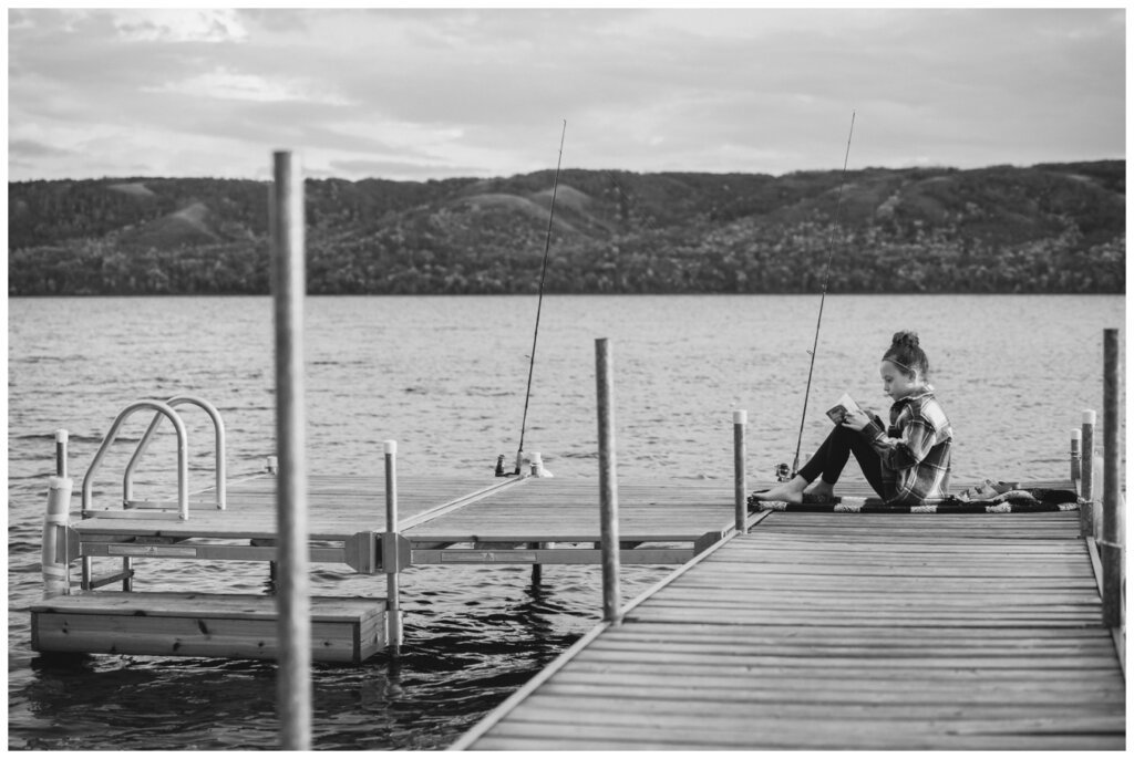 Korchinski Family - Qu'Appelle Valley- 001 - Little girl reads on dock