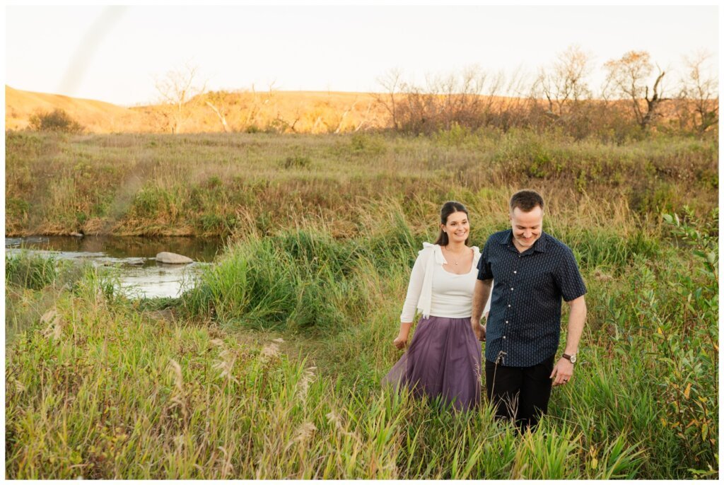 Bill & Lindsay - Regina Family Photographer - Wascana Trails - 005 - Husband leads his wife through the tall grass